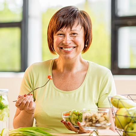 woman smiling and eating