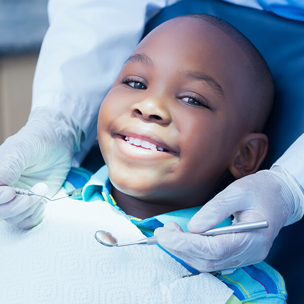 young boy sitting in a dental chair